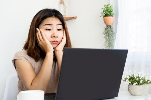 unmotivated woman trying to work quarantine at home office