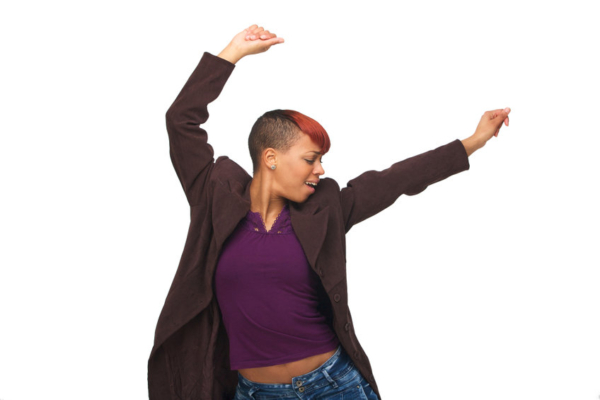 Young African American girl enjoying the music with arms up. Isolated on white background