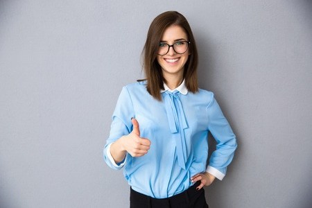 Woman smiling and giving a thumbs up